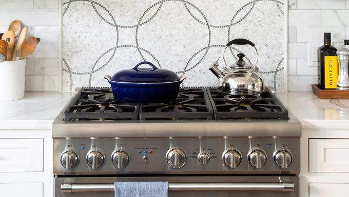A pot and kettle on a clean kitchen stovetop