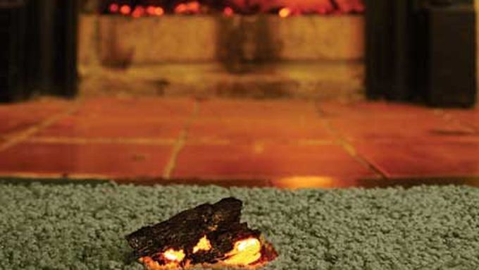 Carpet with a burn mark that can be fixed with a carpet patch.